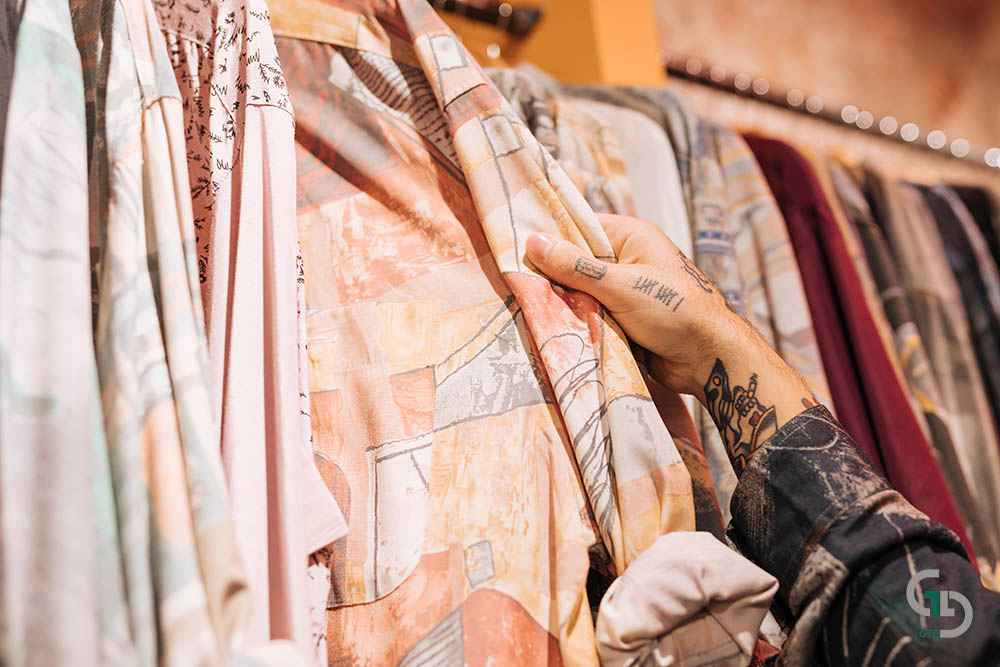 close up male customer s hand choosing shirt hanging rail shop 11zon 1