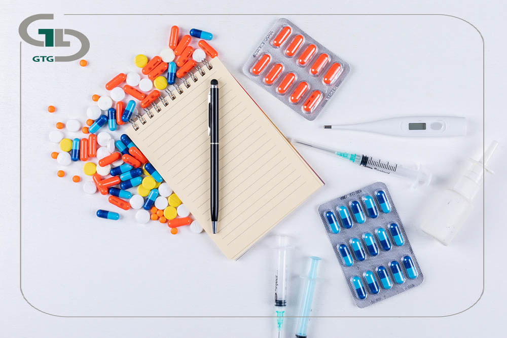 top view colorful pills with notepad pen thermometer nasal spray needle