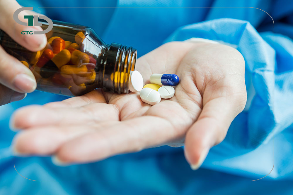woman s hand pours medicine pills out bottle